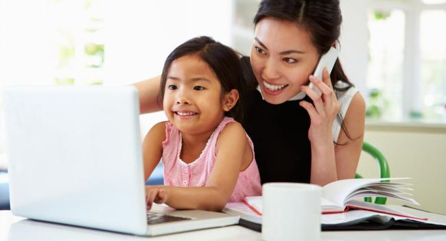 shutterstock_177027683-Mother-on-laptop-and-phone-with-daughter-1